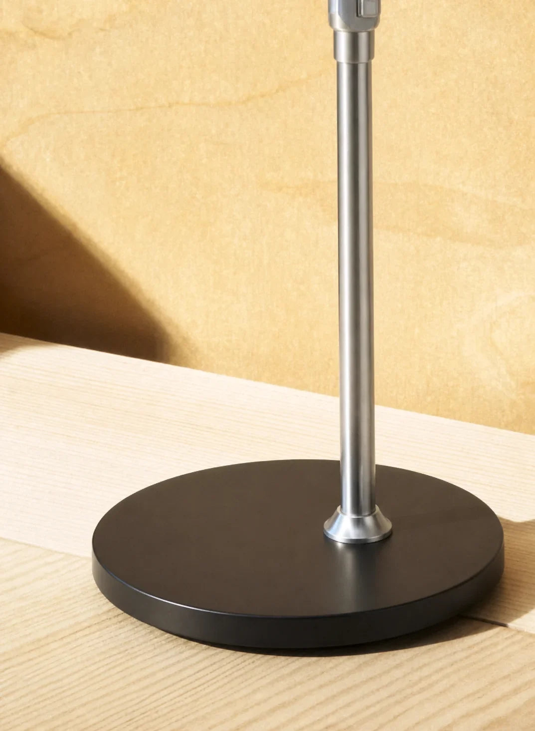 Close view of SOLA Floor's metal upright and circular floor base
