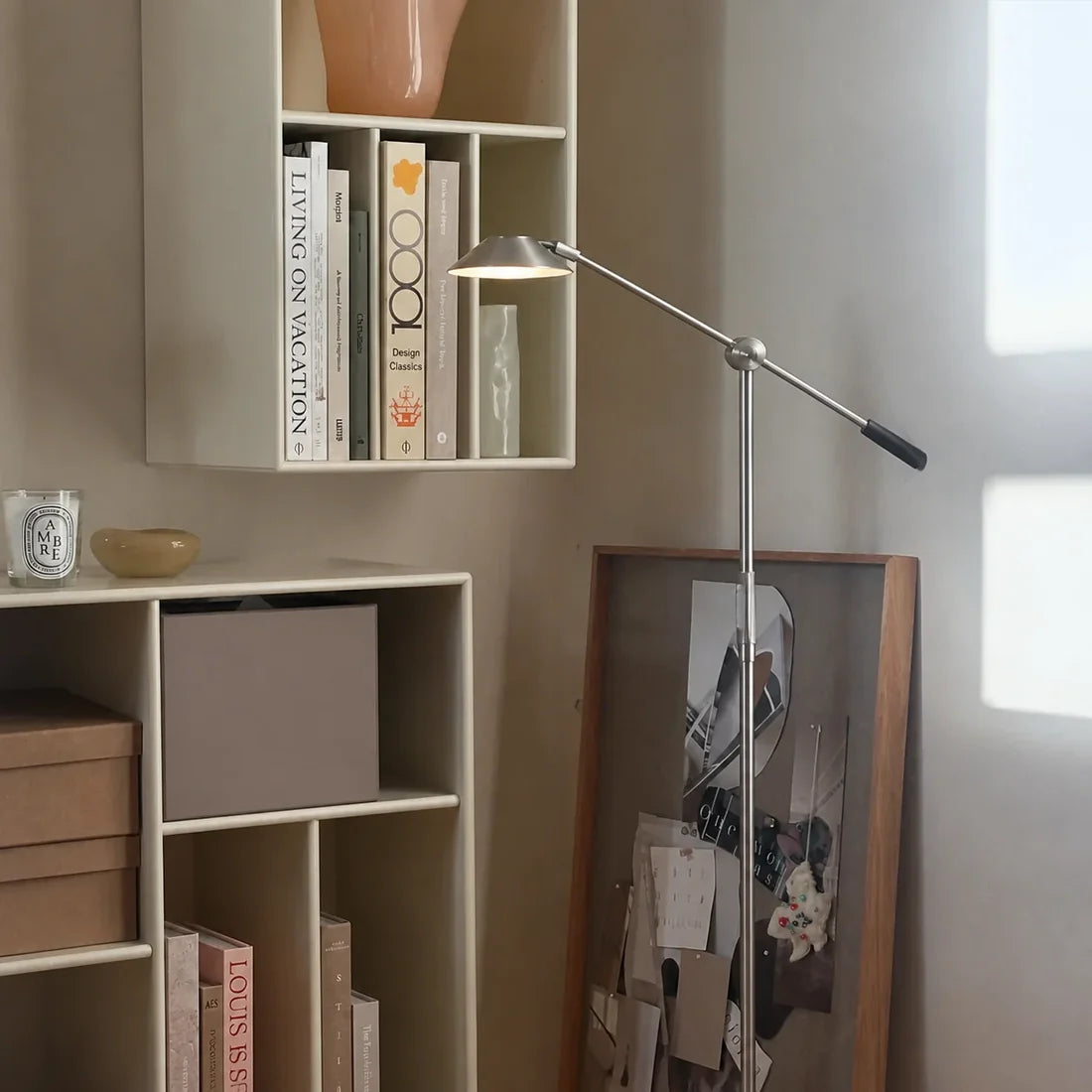 Silver SOLA Floor standing beside shelving and a reading workspace in a home