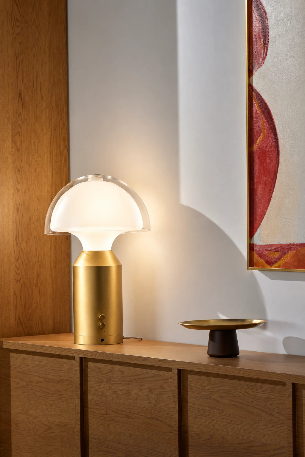 SOLA Halo Plus on a wooden sideboard, lighting the wall, art and objects