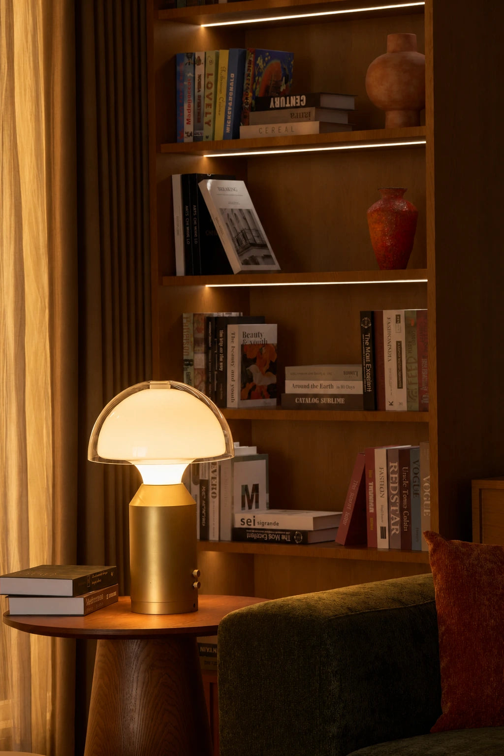 SOLA Halo Plus on a round table beside bookshelves and a reading chair